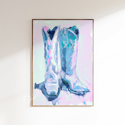 Framed artwork of abstract cowboy boots in blue and pink on a light background