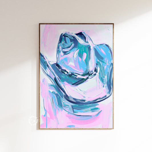 Abstract art print with blue and pink colors in a wooden frame on a white wall.