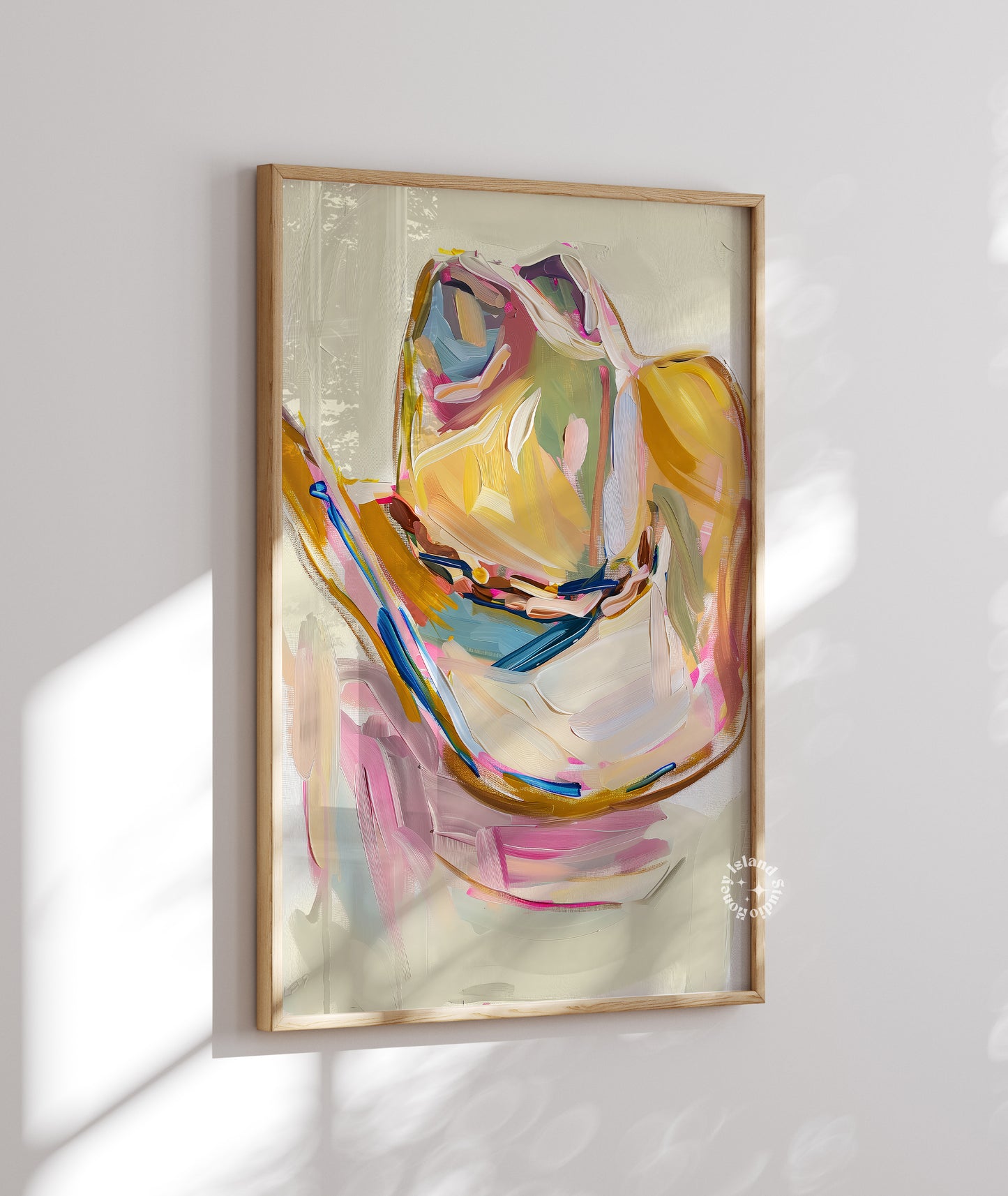 Cowgirl hat art painting in a wooden frame on a white wall