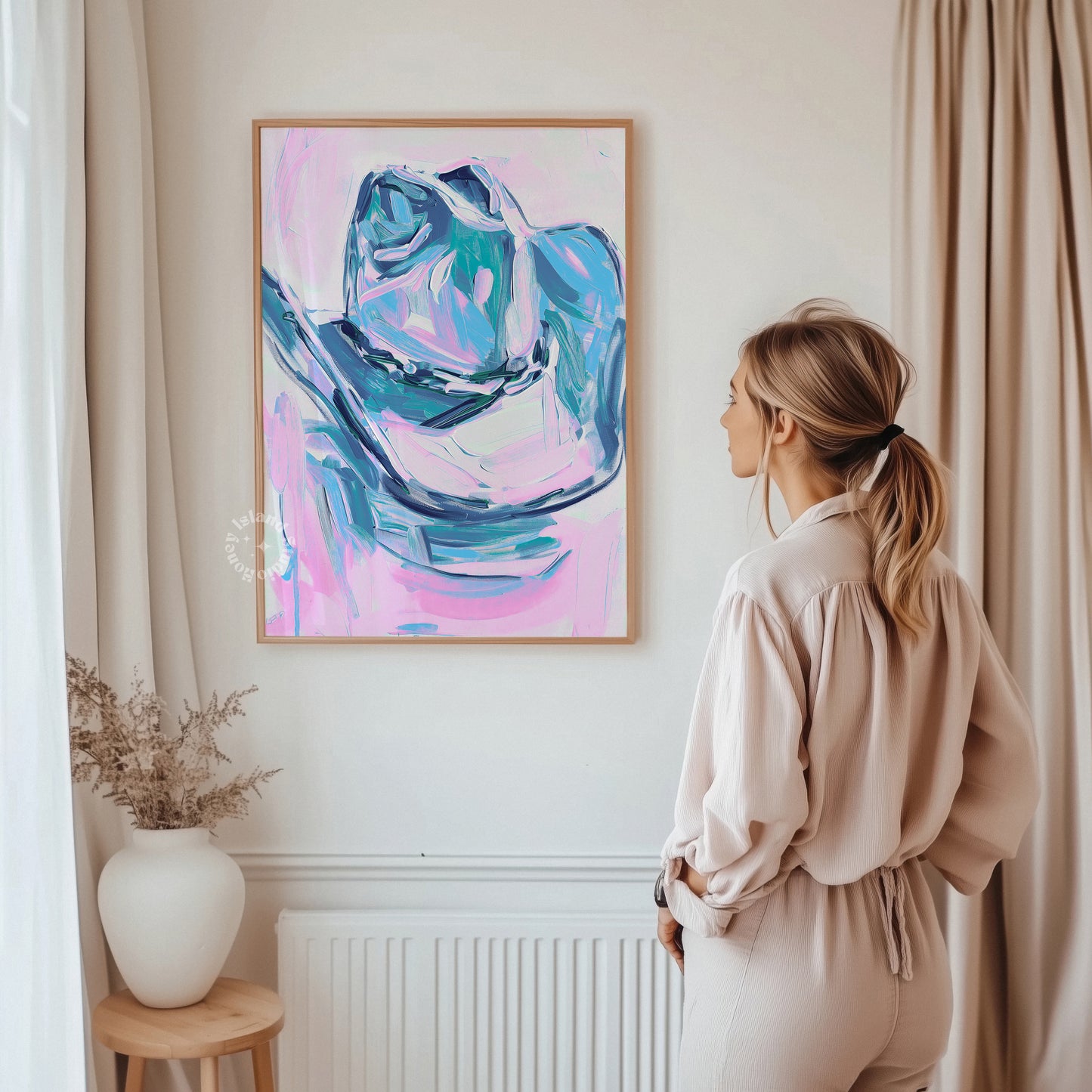 Woman standing in a room looking at an abstract painting on the wall.