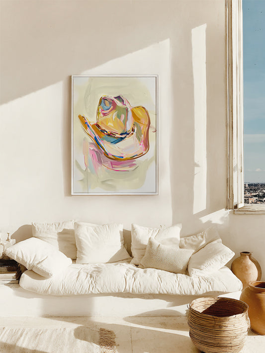 Living room with a white sofa, colorful abstract painting, and natural light.
