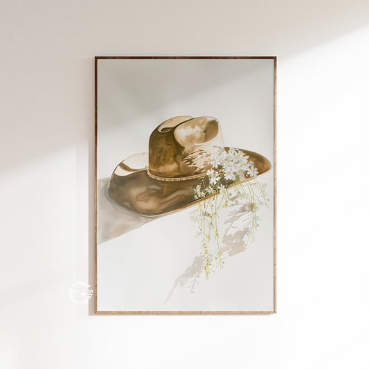 Framed artwork of a cowboy hat with flowers on a light background