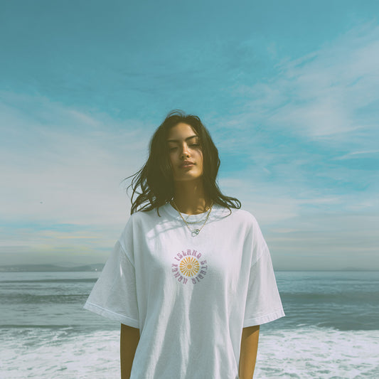 Woman wearing a white t-shirt with a graphic design on a beach