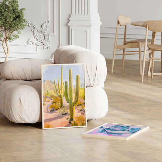 artwork of a desert scene with cacti on a wooden floor in a living room.