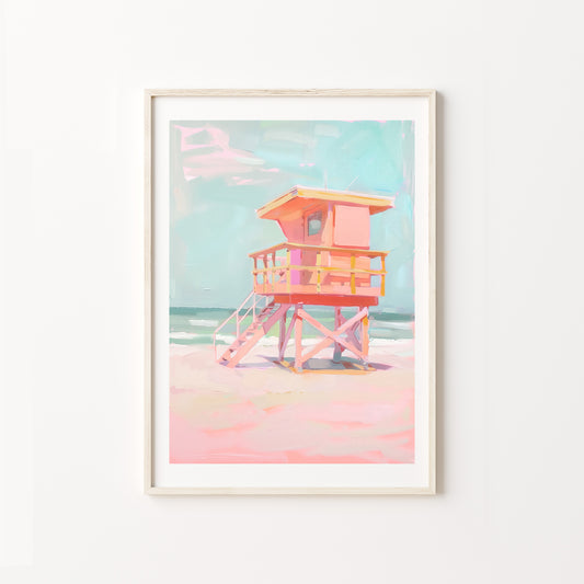 Framed artwork of a colorful lifeguard tower on a beach with a pastel color palette.