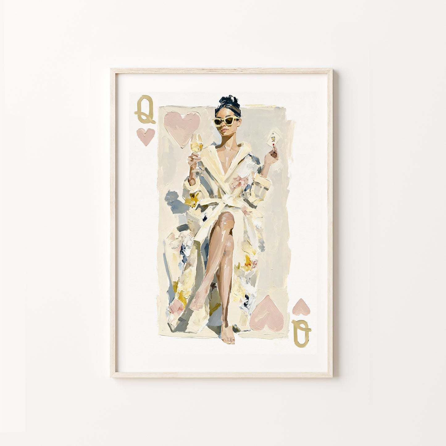 Framed artwork of a queen of hearts in a robe with playing card design elements on a white wall.