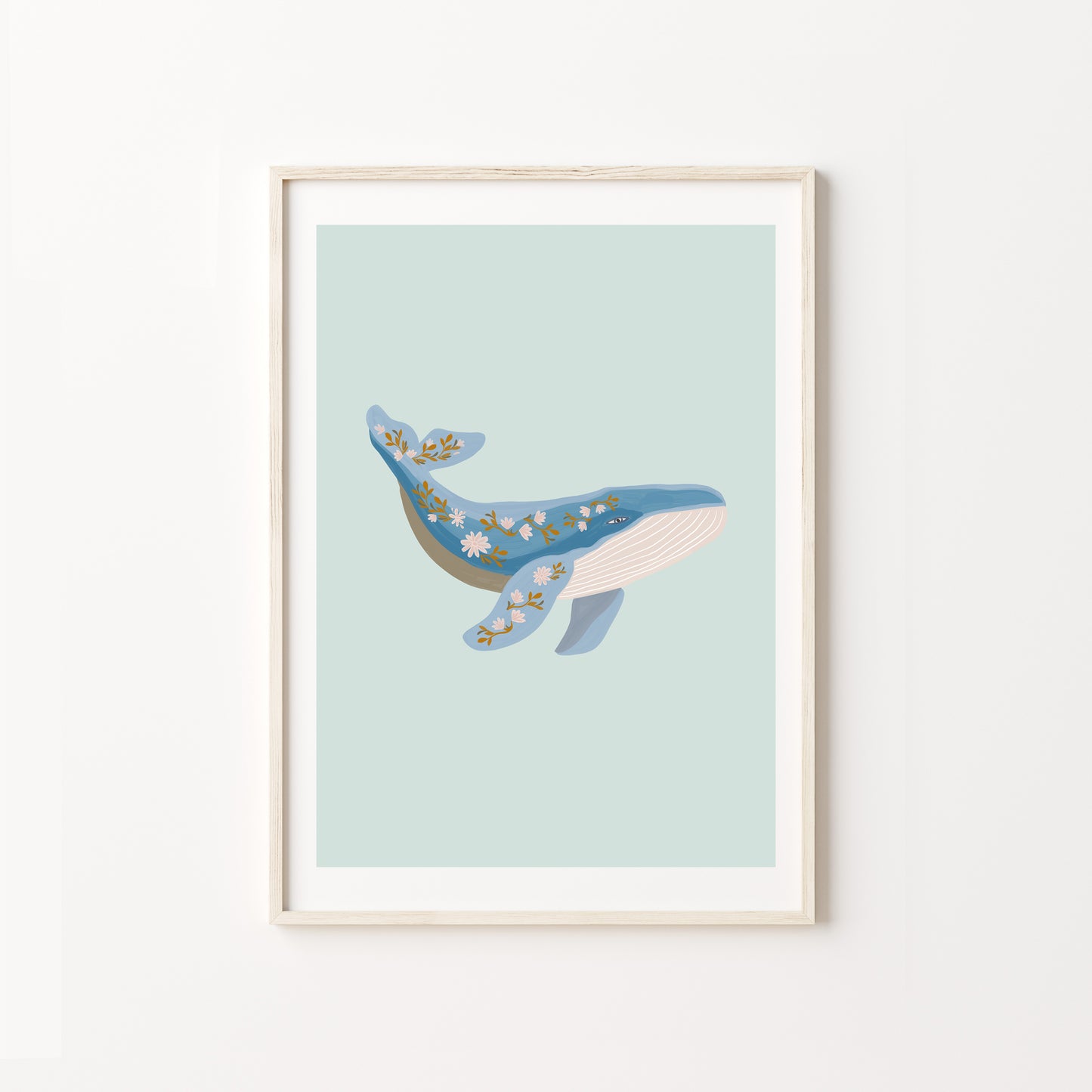 Framed artwork of a whale on a light blue background