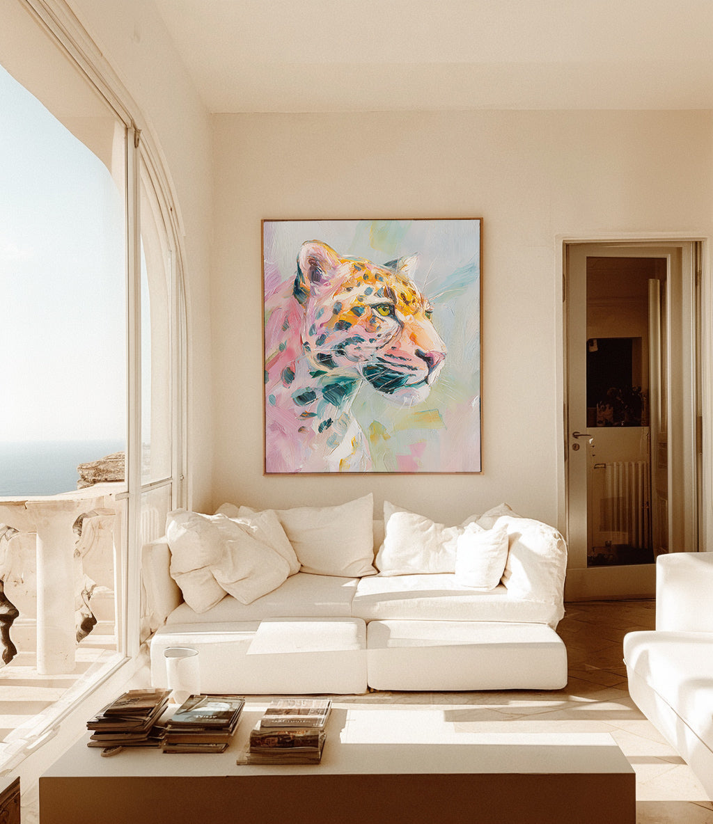 Living room with a white sofa, coffee table, and colorful abstract painting of a leopard on the wall.