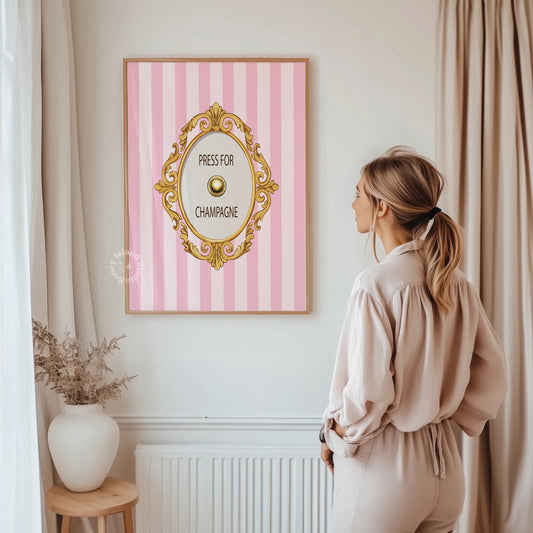 Woman standing in a room with a pink and white striped wall art featuring a gold frame and text.