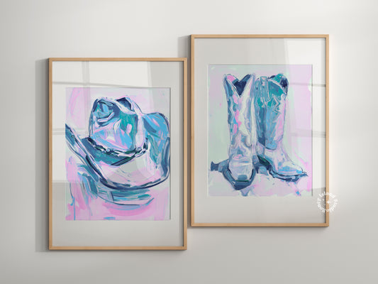 Two framed abstract artworks of boots on a light gray wall.