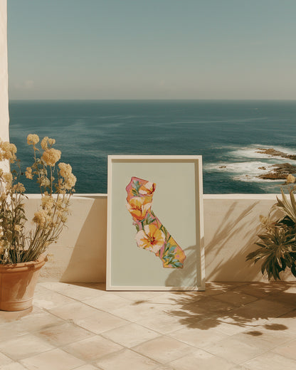 Framed floral artwork on a patio with ocean view
