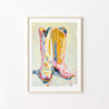 Framed artwork of colorful cowboy boots on a light background
