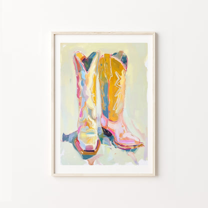 Framed artwork of colorful cowboy boots on a light background