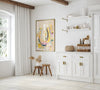 Modern kitchen interior with white cabinets, a colorful horseshoe artwork, and decorative items.