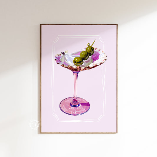 Framed artwork of a cocktail with olives on a pink background