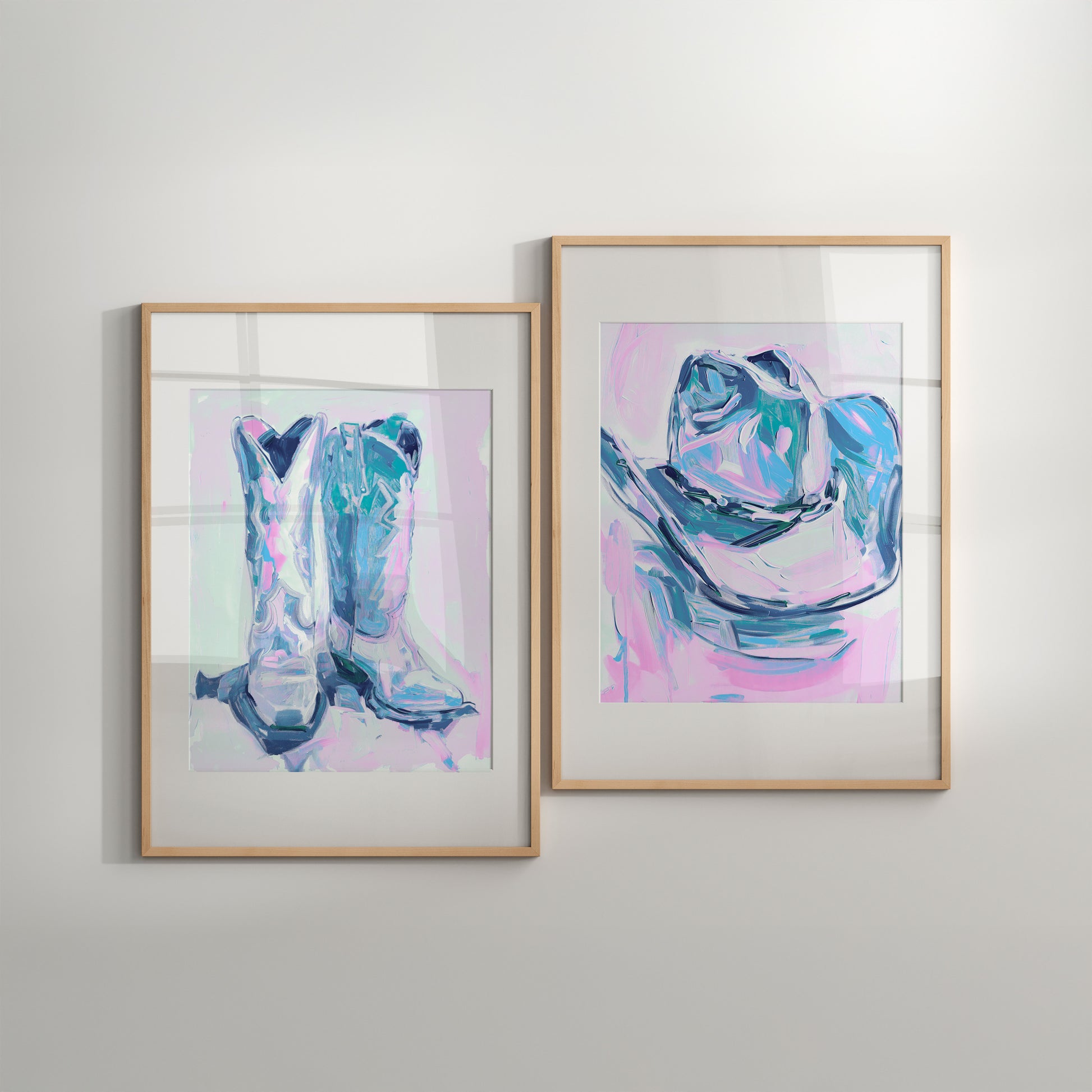 Two framed abstract art pieces of cowboy boots on a light gray wall.