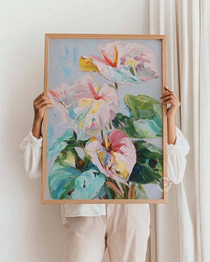 Person holding a framed painting of colorful flowers against a white wall.