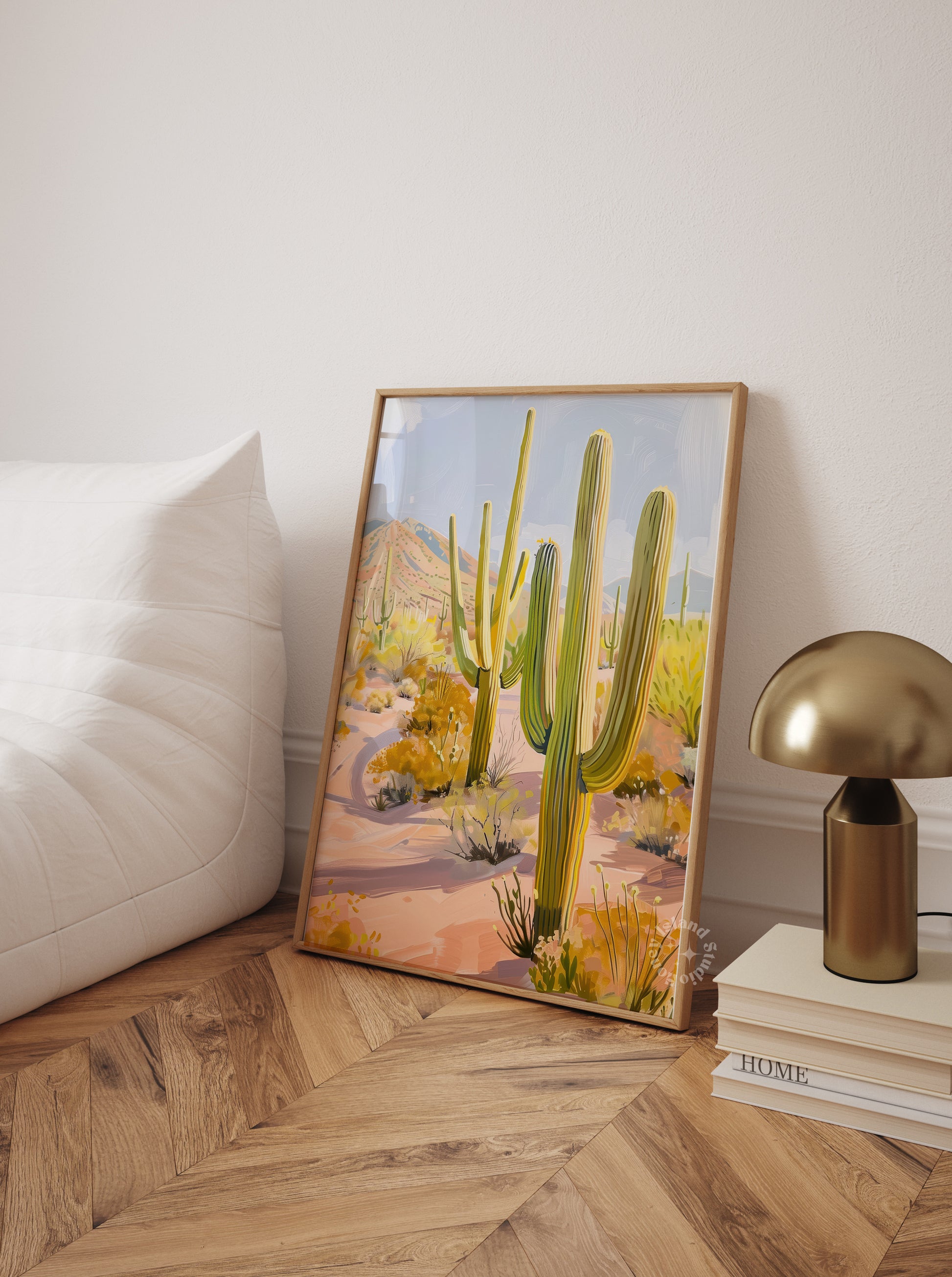 Framed artwork of a desert scene with cacti in a beedroom floor