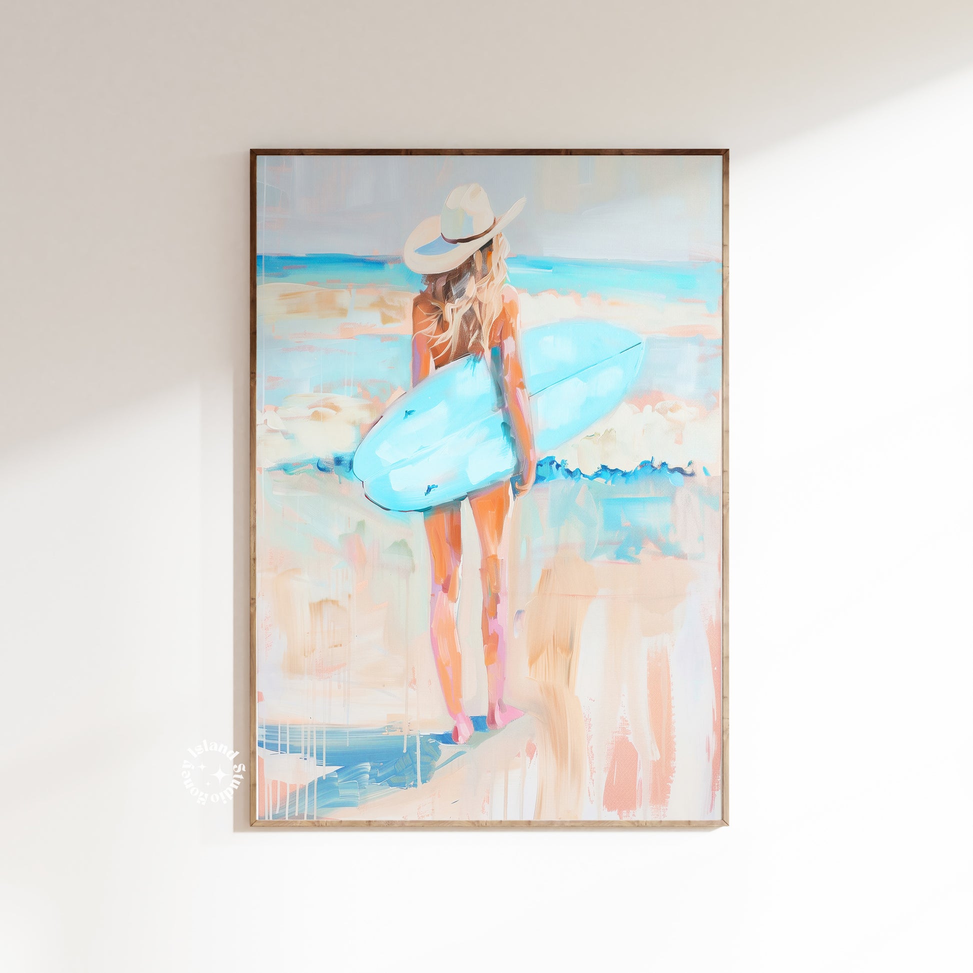 Framed artwork of a woman with a hat and blue bag on a beach.