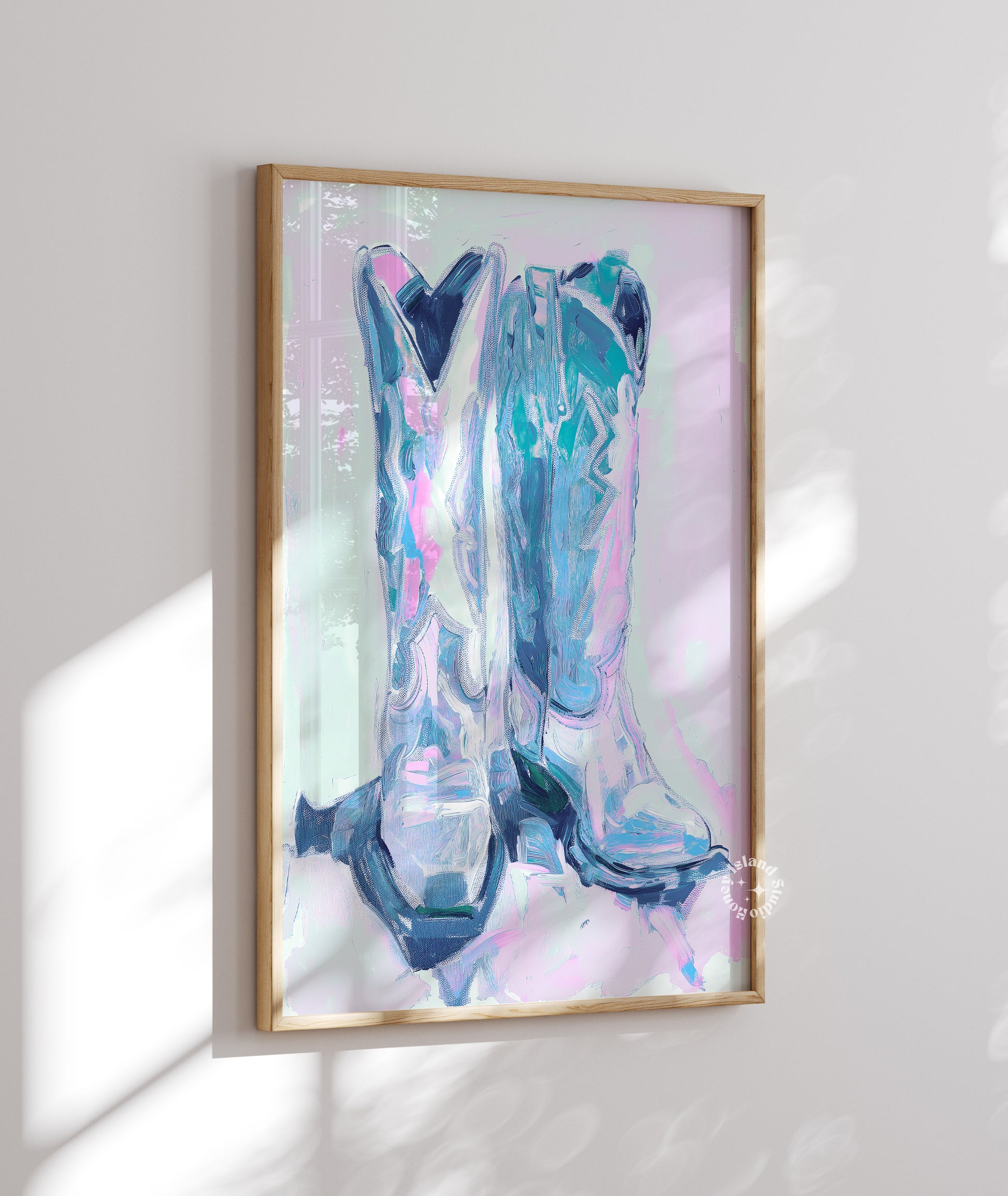 Framed abstract artwork of cowboy boots on a white wall