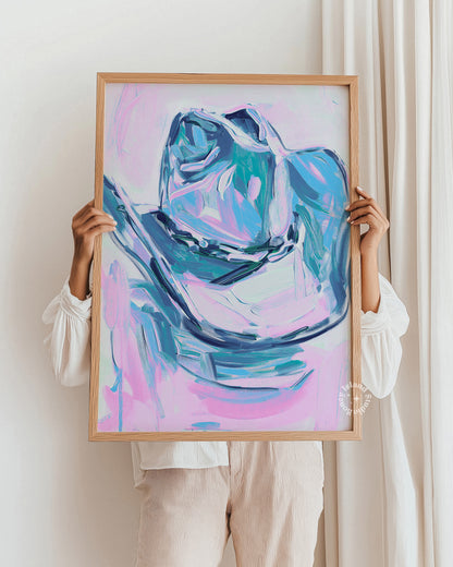 Person holding a framed abstract painting with a colorful design.