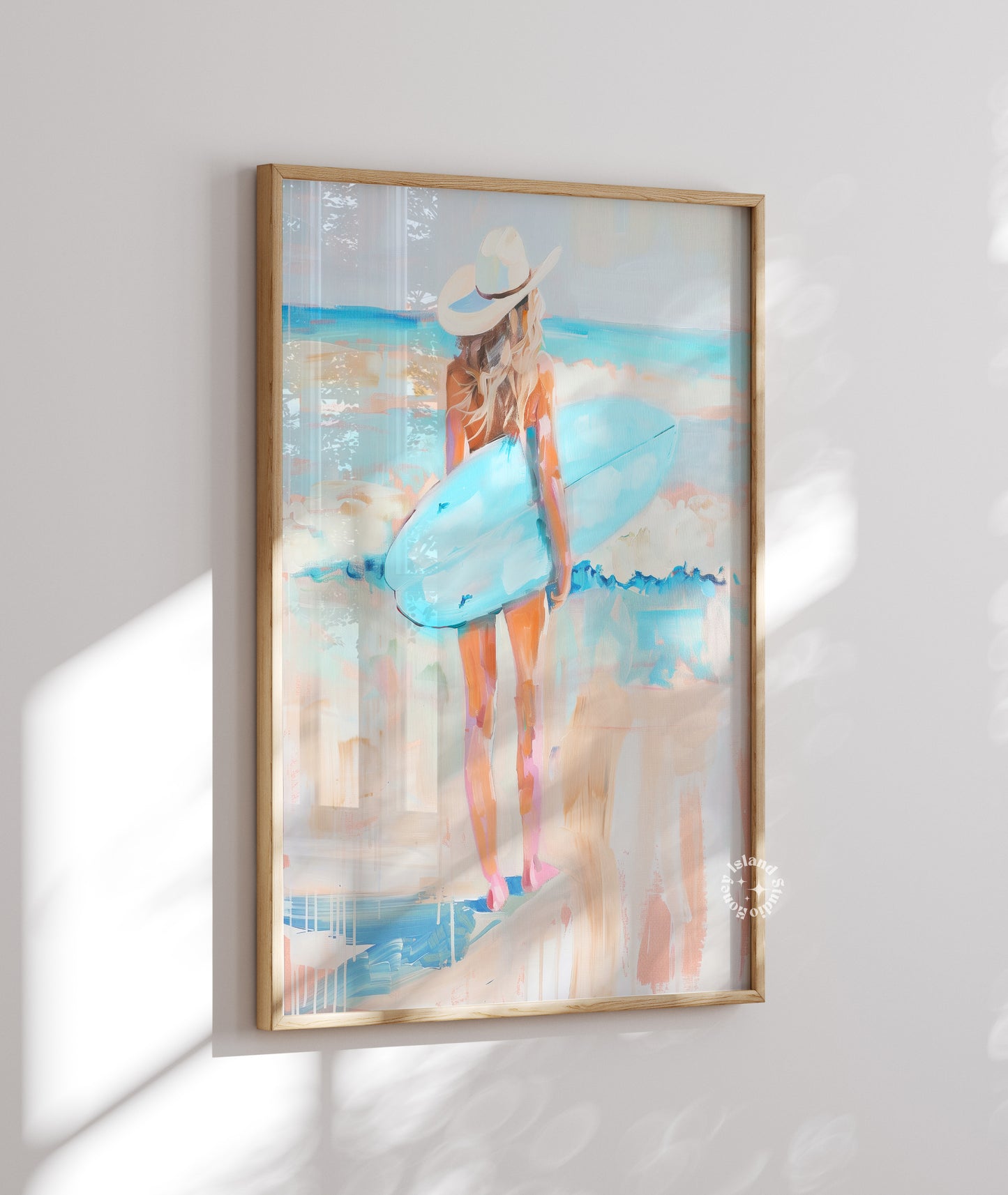 Framed artwork of a woman in a blue dress and white hat on a white wall.