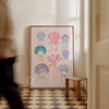 Framed artwork of colorful shell designs on a wall in a room with checkered floor.