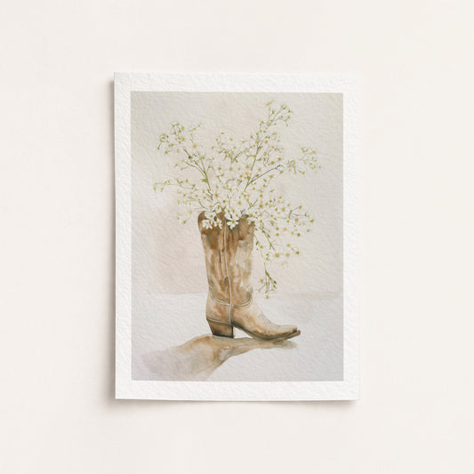 Framed artwork of a cowboy boot with flowers on a light background