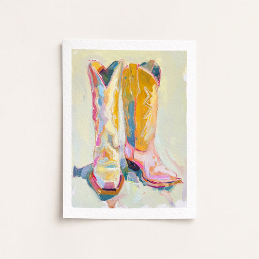 Framed artwork of colorful cowboy boots on a light background