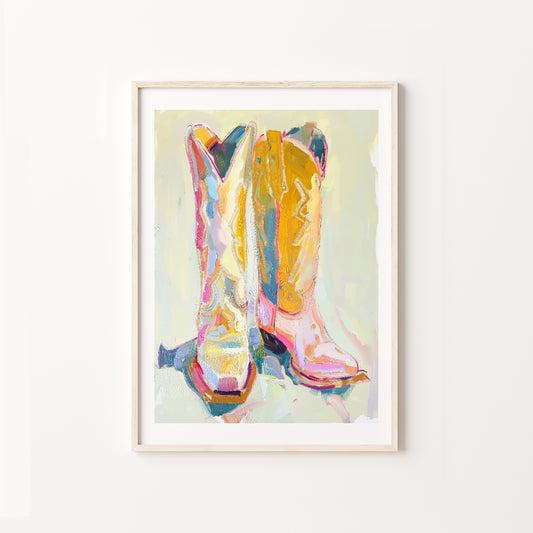 Framed artwork of colorful cowboy boots on a white background