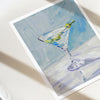 Artistic depiction of a martini glass with olives on a textured surface