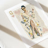 Illustration of a queen of hearts in a robe with playing card symbols on a white surface