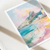 Colorful watercolor painting of a coastal scene with mountains and people on a white surface arpoador rio de janeiro brazil 