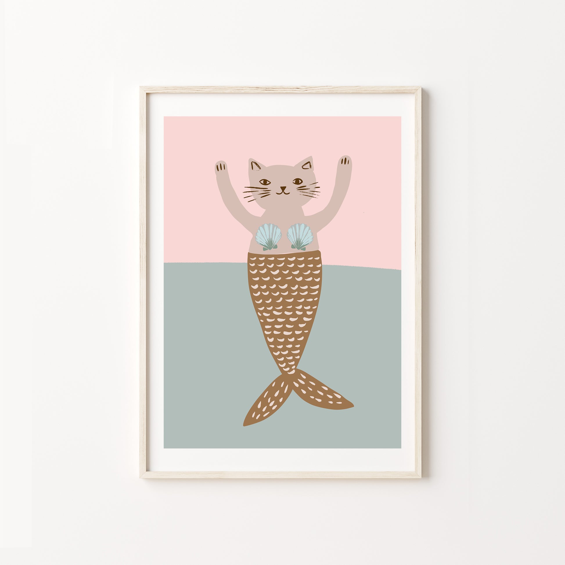 Framed artwork of a cat with a mermaid tail on a pink and blue background
