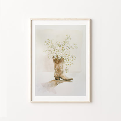 Framed artwork of a cowboy boot with flowers on a white background