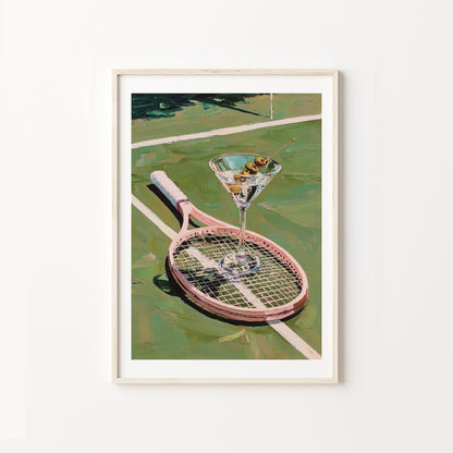 Framed artwork of a martini glass on a tennis racket on a tennis court.