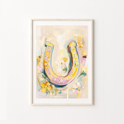 Colorful horseshoe artwork in a frame on a white wall