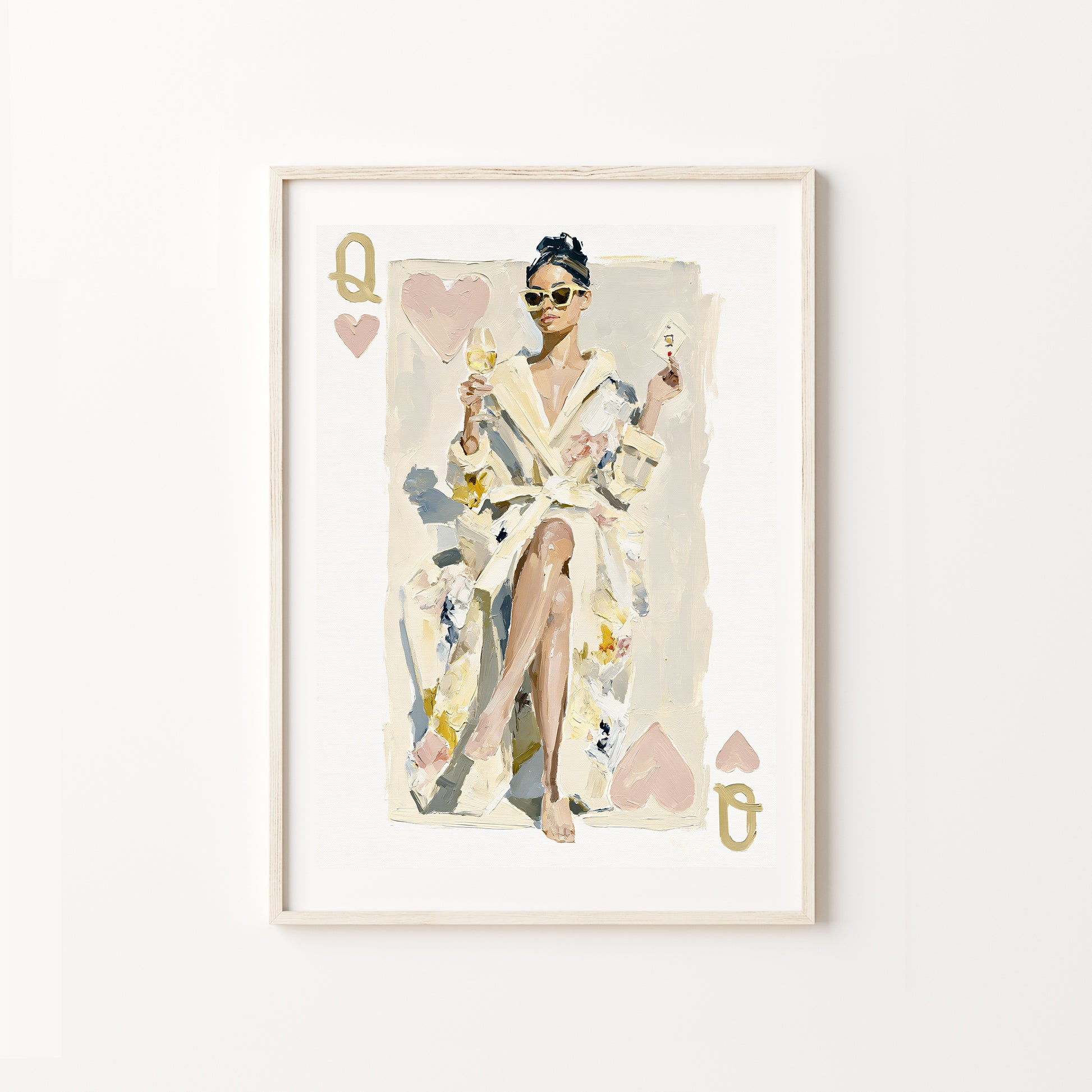 Framed artwork of a queen of hearts in a robe with playing card design elements on a white wall.