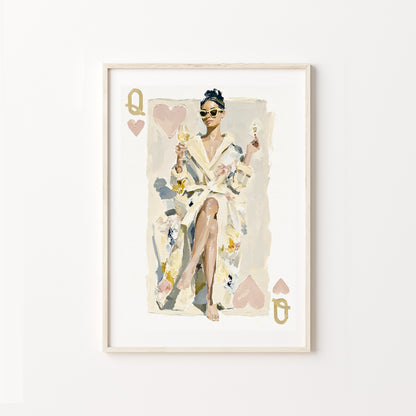 Framed artwork of a queen of hearts in a robe with playing card design elements on a white wall.