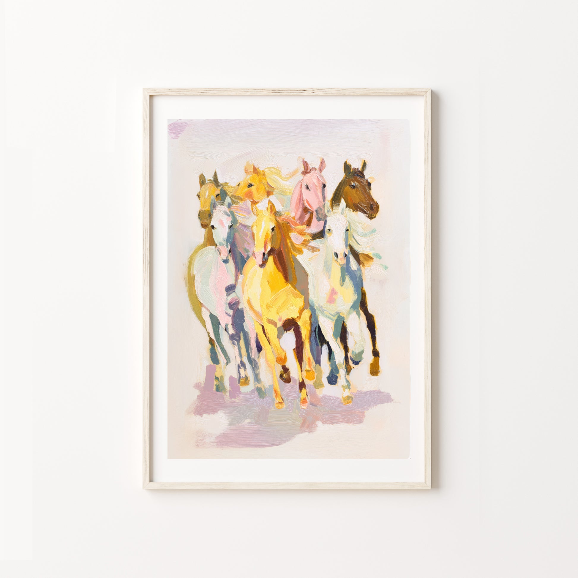 Framed artwork of colorful horses on a white wall