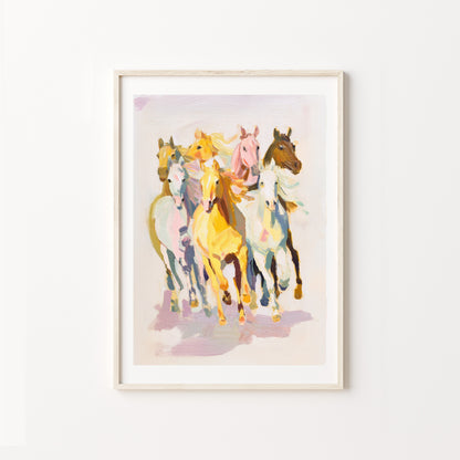 Framed artwork of colorful horses on a white wall