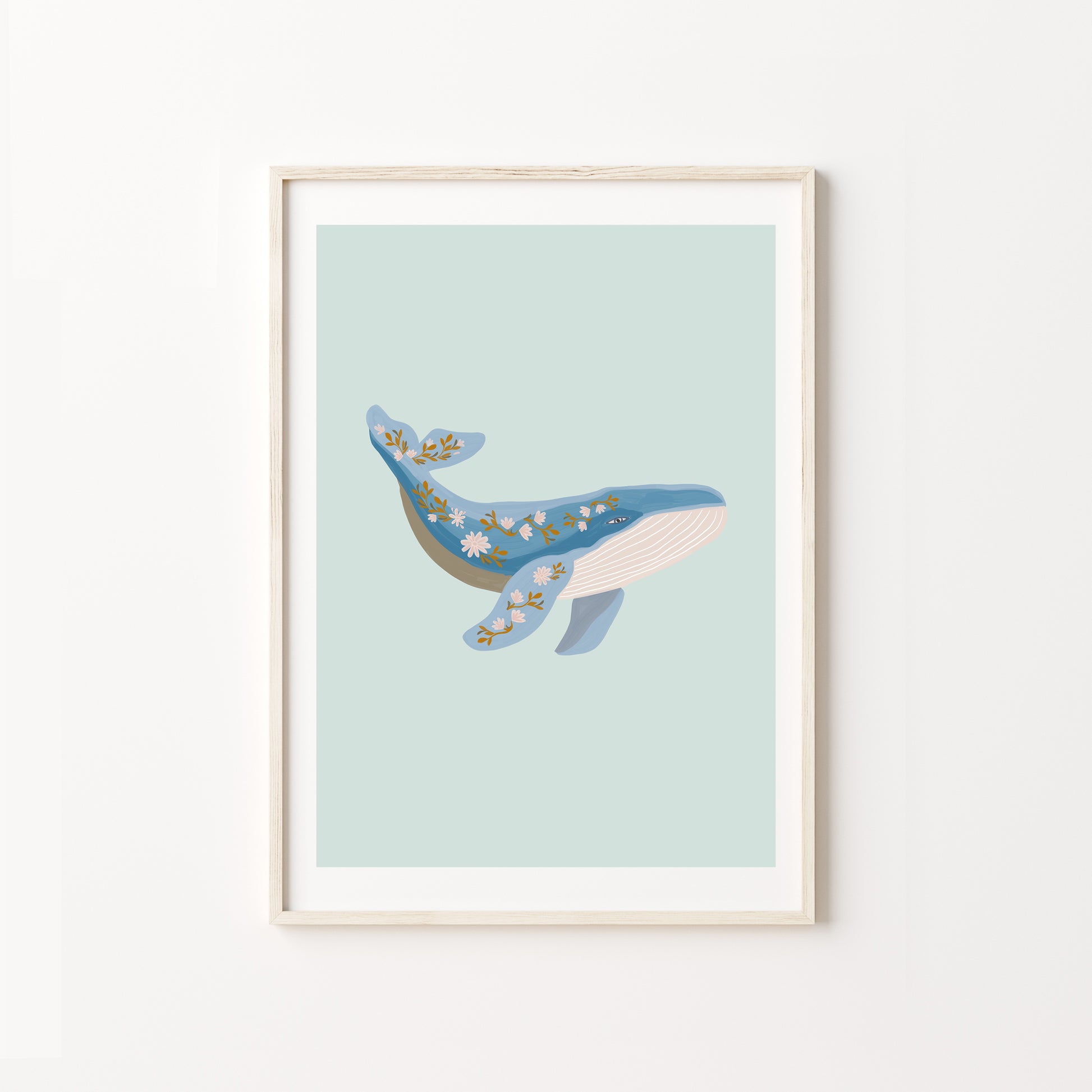 Framed artwork of a whale on a light blue background