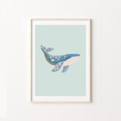 Framed artwork of a whale on a light blue background