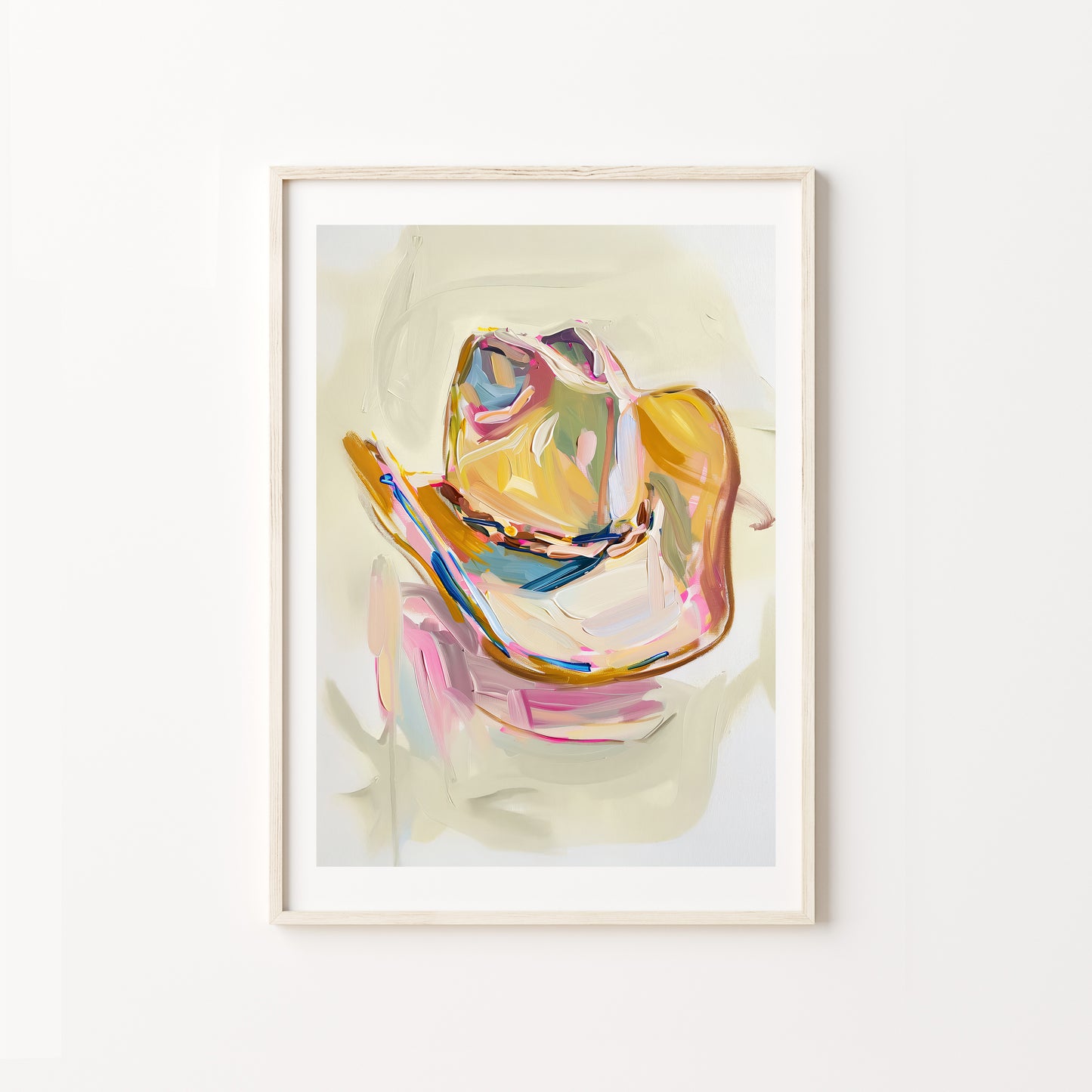 Framed abstract art print of a colorful cowboy hat on a white wall