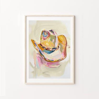 Framed abstract art print of a colorful cowboy hat on a white wall