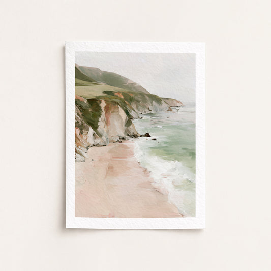 Framed artwork of a coastal landscape with cliffs and beach.