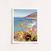 Framed artwork of a coastal scene with flowers in the foreground