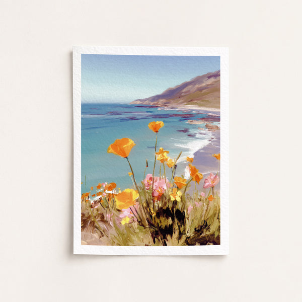 Framed artwork of a coastal scene with flowers in the foreground