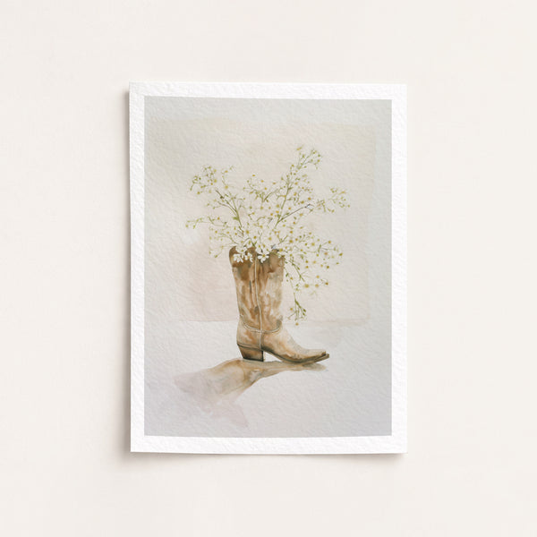 Framed artwork of a cowboy boot with flowers on a light background