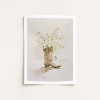 Framed artwork of a cowboy boot with flowers on a light background